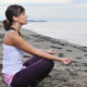 woman yoga beach deep breathing exercises